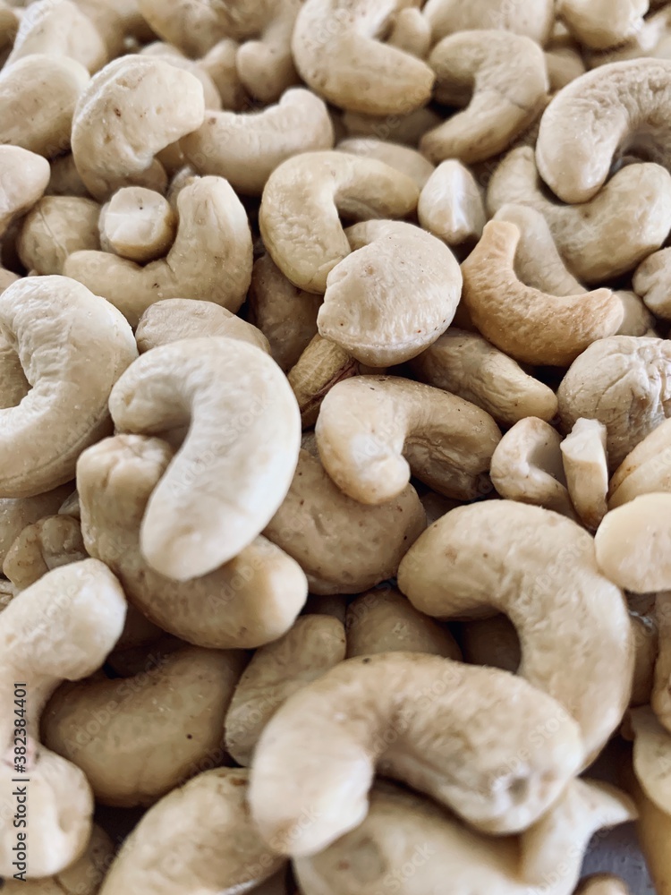 Nuts Cashews are scattered as a background on a table. Nuts Cashews are scattered as a background on a table.