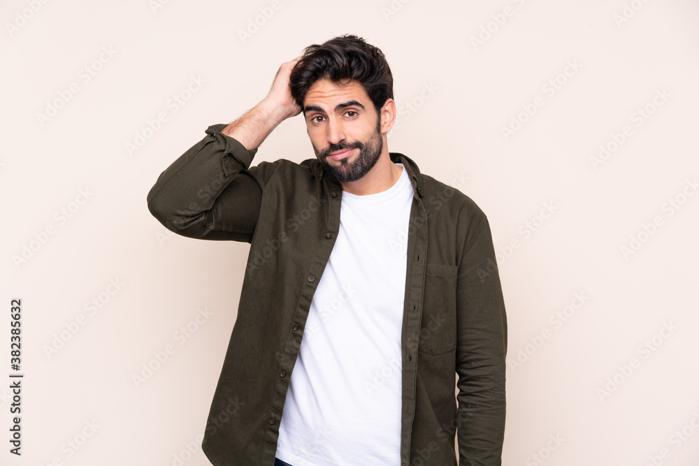 Young handsome man with beard over isolated background with an expression of frustration and not understanding Young handsome man with beard over isolated background with an expression of frustration and not understanding