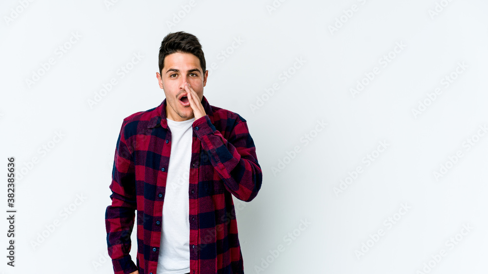 Young caucasian man isolated on white background is saying a secret hot braking news and looking aside Young caucasian man isolated on white background is saying a secret hot braking news and looking aside