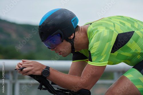 triathlon athlete riding a bike on morning training