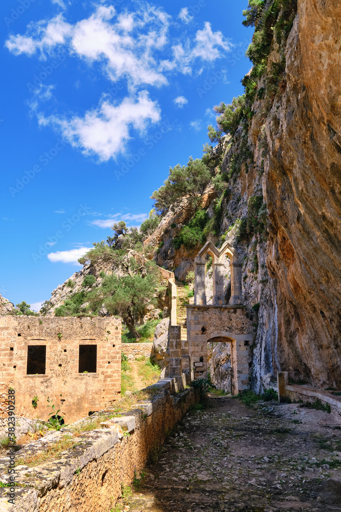 Ruins of entrance gate to abandoned Orthodox Katholiko monastery in Avlaki gorge, Akrotiri peninsula, Chania, Crete, Greece. Spring daytime.