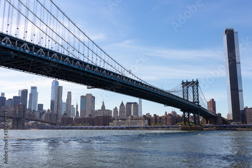 Manhattan Bridge over the East River with a view of the Manhattan Skyline in New York City