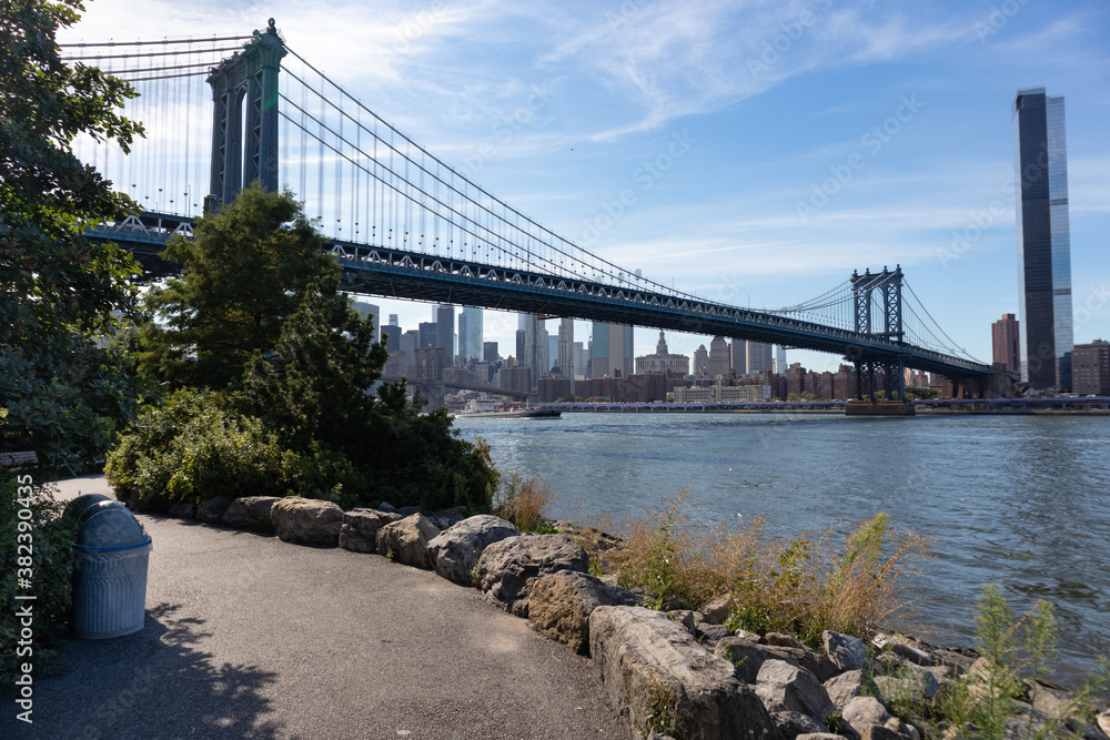 Empty Trail on the Dumbo Brooklyn Riverfront with the Manhattan Bridge over the East River in New York City