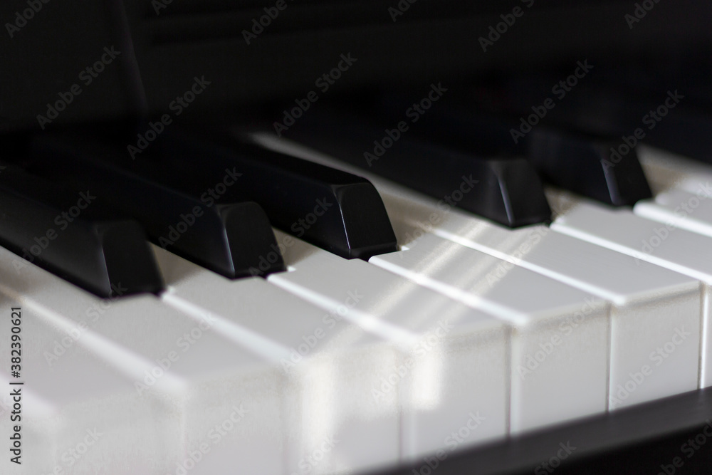 Black and white piano keys in dim lighting and shadows. Black and white piano keys in dim lighting and shadows.