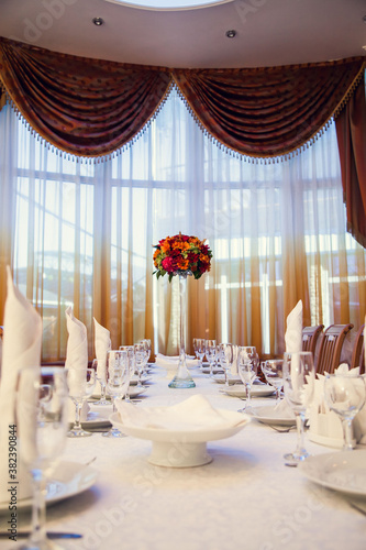 Autumn bouquet of flowers decorates the festive table in the restaurant