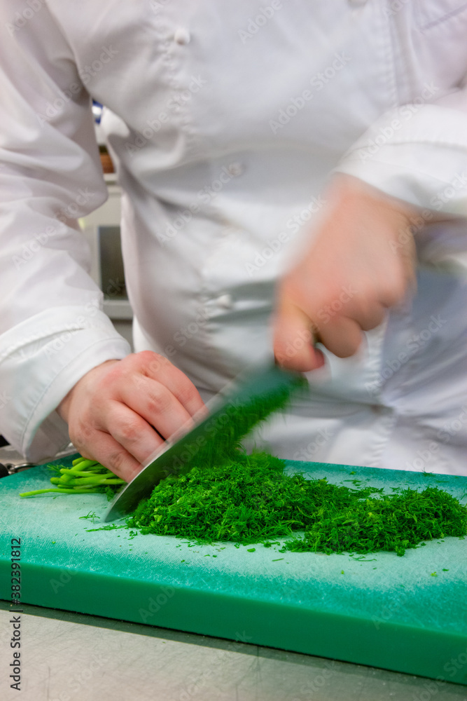 chef chopping fresh herbs on chopping board chef chopping fresh herbs on chopping board