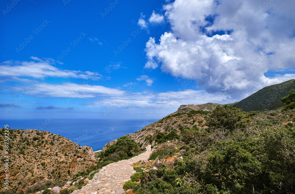 Typical Greek or Cretan landscape, hills and mountains, spring foliage, bush, olive tree, rocky road, path. Akrotiri peninsula, Chania, Crete, Greece Typical Greek or Cretan landscape, hills and mountains, spring foliage, bush, olive tree, rocky road, path. Akrotiri peninsula, Chania, Crete, Greece