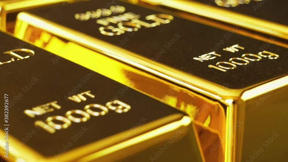 Gold bricks. Stack of gold bullion bars. The camera pans around gold bars. Handheld shot in close up Gold bricks. Stack of gold bullion bars. The camera pans around gold bars. Handheld shot in close up