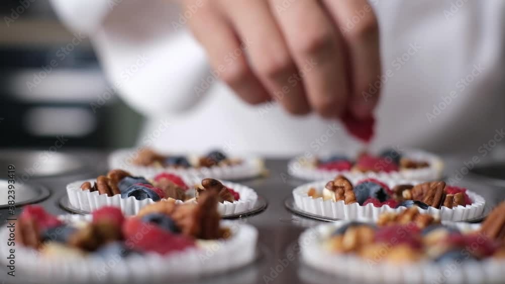 Pastry chef making mixed berry muffin with almond and nut. set on cafe table. Pastry chef making mixed berry muffin with almond and nut. set on cafe table.