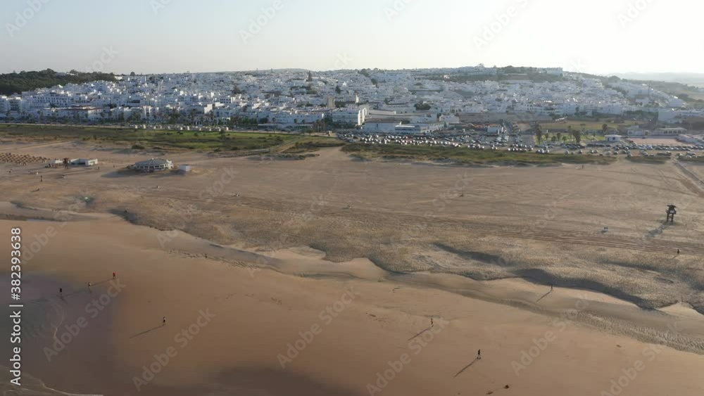 Aerial drone view of the Atlantic south Spanish beach in Conil de la Frontera and white town Aerial drone view of the Atlantic south Spanish beach in Conil de la Frontera and white town