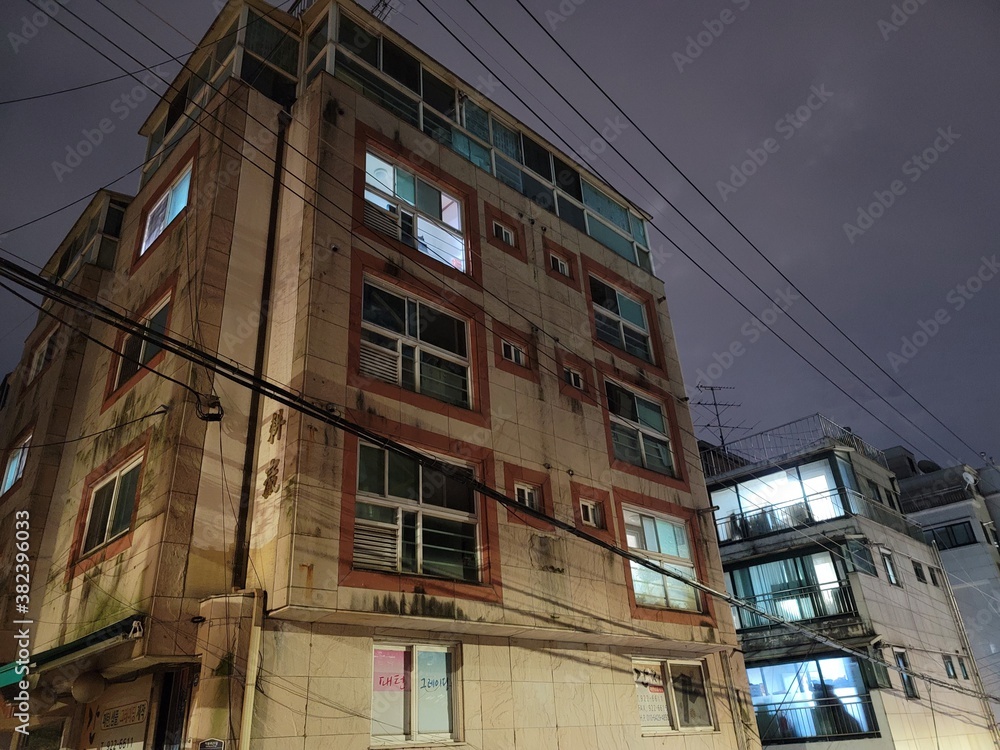 it is old building with electric wire in the sky (color)
