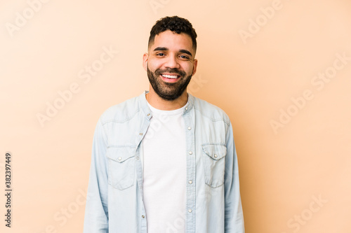 Young mixed race arabic man isolated happy, smiling and cheerful.