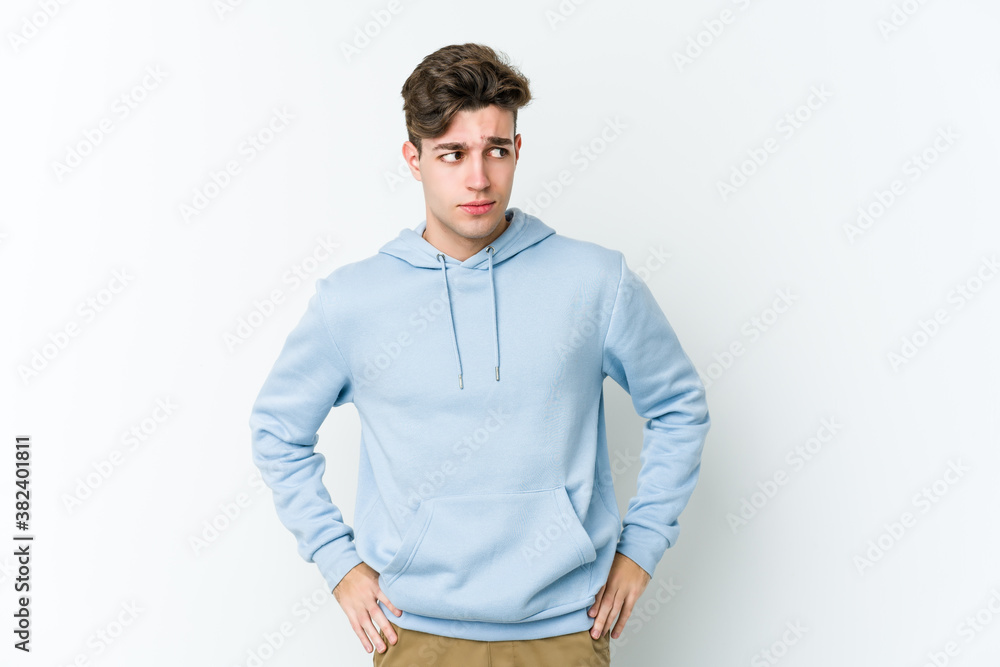 Fototapeta premium Young caucasian man isolated on white background confused, feels doubtful and unsure.