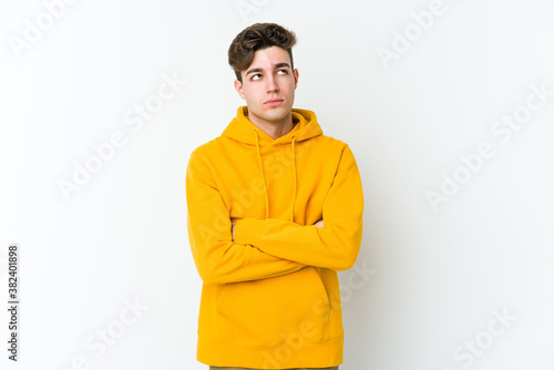 Young caucasian man isolated on white background tired of a repetitive task.