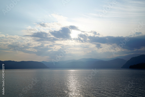 Sunrise over the foggy Altai lake 