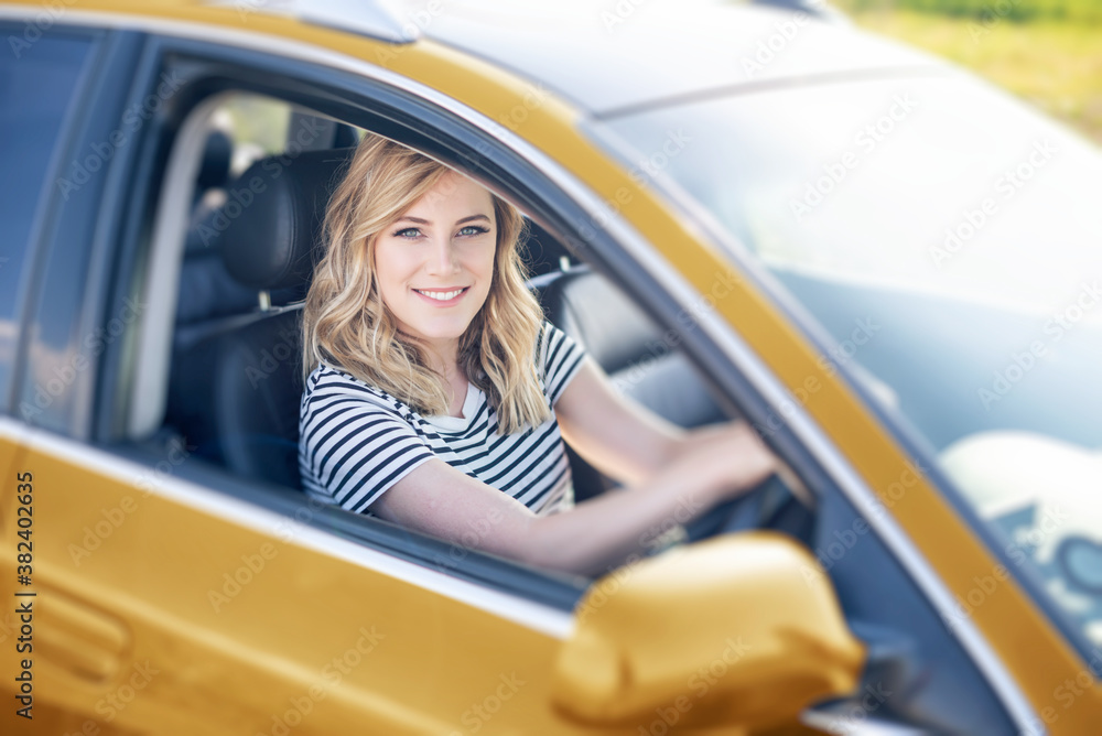 The blonde in the car. Attractive woman drives a car.