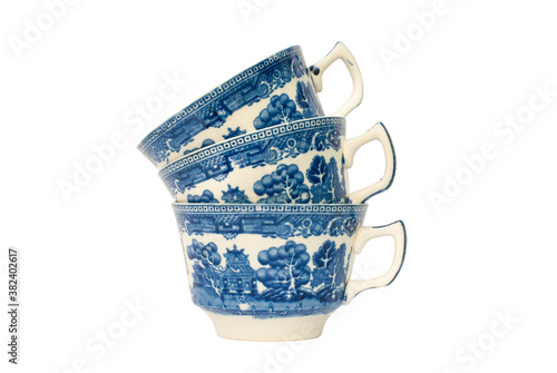 Photography Stack of three blue and white porcelain cups with a pretty floral design
