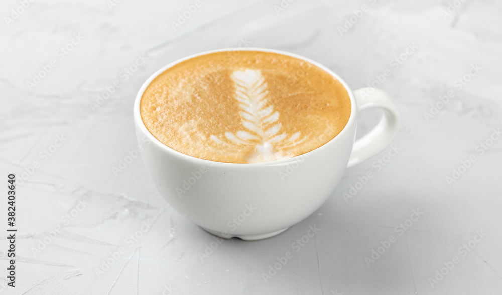 White cup of hot cappuccino coffee on concrete background White cup of hot cappuccino coffee on concrete background