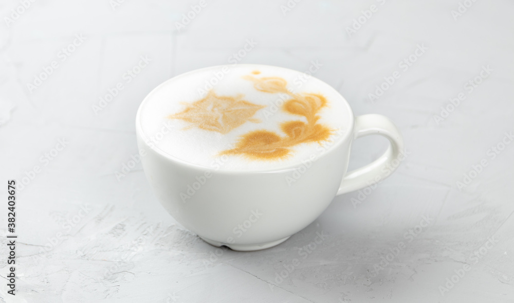 White cup of hot mochacino coffee on concrete background White cup of hot mochacino coffee on concrete background