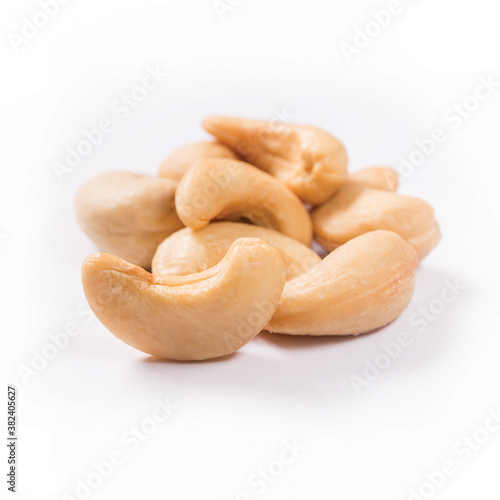Composition of salted and roasted cashews on a white background