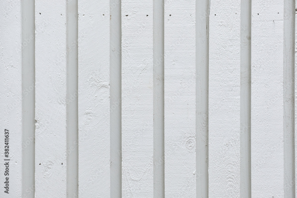 The modern white wooden wall of the building. The pattern of wooden wall.