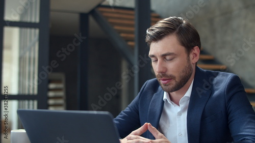 Joyful businessman making web call on laptop camera. Guy making conference call © stockbusters