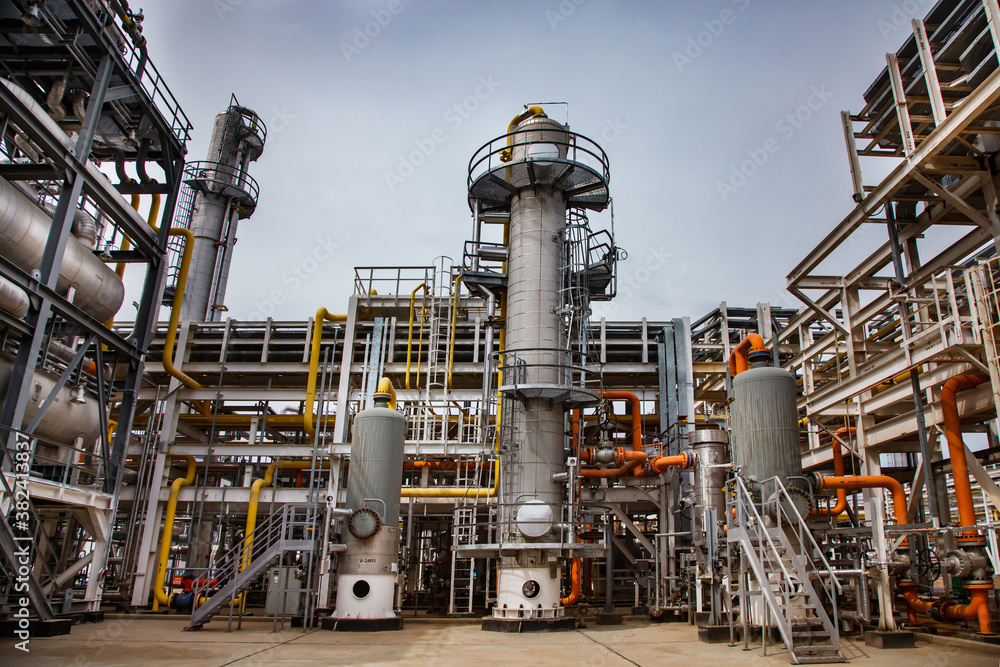 Oil refinery and gas processing plant. Distillation tower (refining column), pipelines and tubes, heat exchangers and tanks.