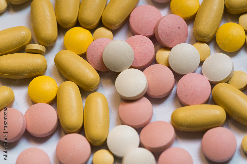Different pills on color background, flat lay. COVID-19 (coronavirus) drugs Different pills on color background, flat lay. COVID-19 (coronavirus) drugs