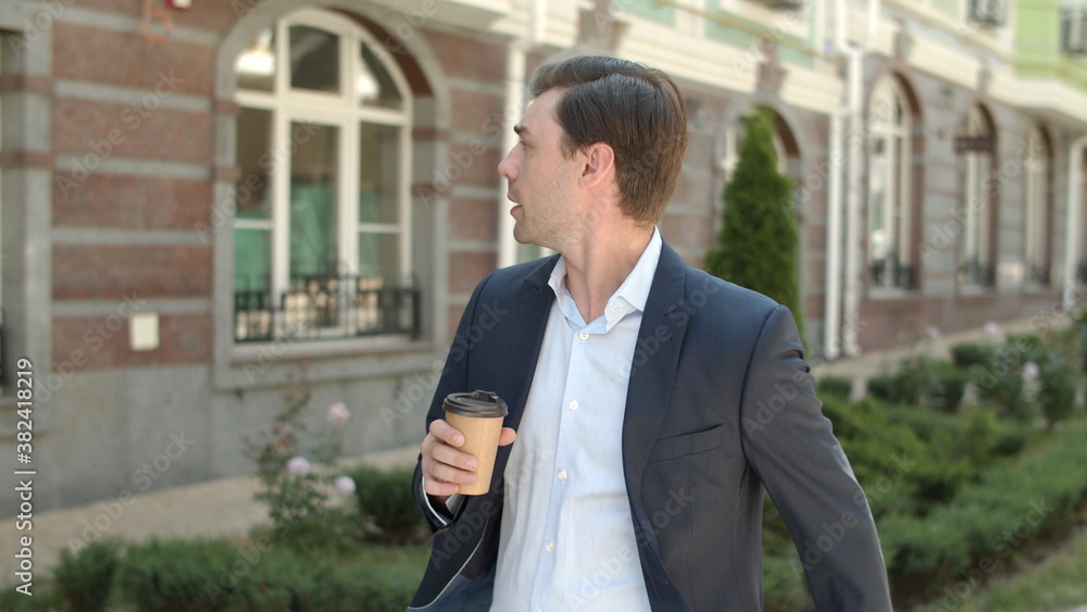 Man drinking coffee before work. Businessman looking at smart watch Man drinking coffee before work. Businessman looking at smart watch