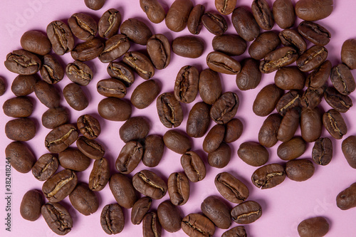Coffee beans on a pink background. Coffee concept.