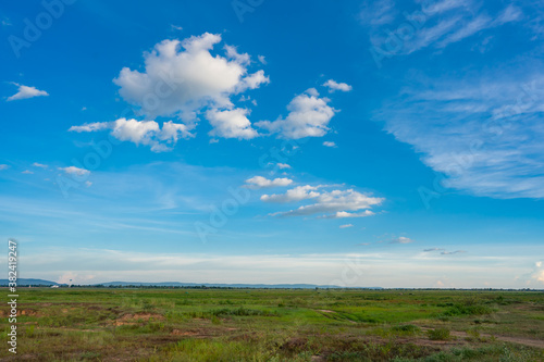 Blue sky and white cloud over land background