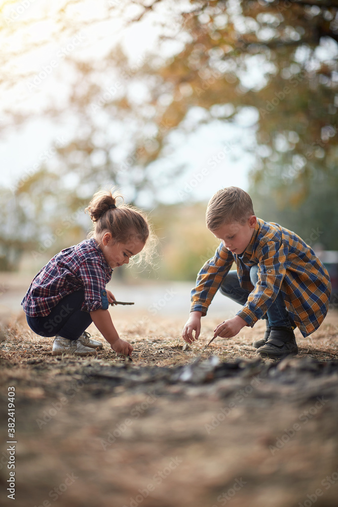 Brother and sister playing in the woods; Spring or autumn hiking in nature; camping, travel, tourism,lifestyle, hike and people concept. Quality active family time together. Brother and sister playing in the woods; Spring or autumn hiking in nature; camping, travel, tourism,lifestyle, hike and people concept. Quality active family time together.