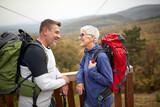 Senior couple hiking; Spring or autumn hiking in nature; camping, travel, tourism,lifestyle,  hike and people concept. Quality active family time together.