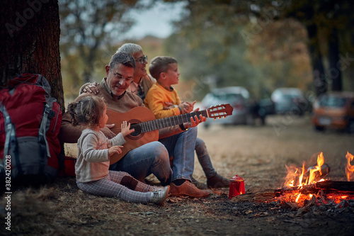 Grandparents singing with grandchildren; Quality family time concept