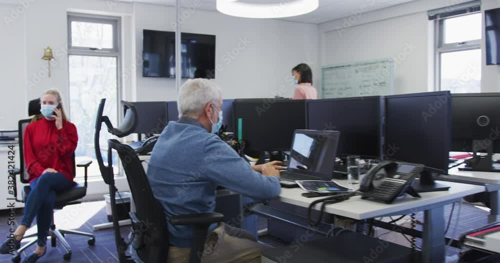 Man wearing face mask using digital tablet at office Man wearing face mask using digital tablet at office