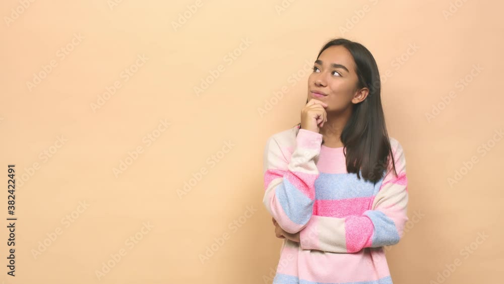 Young mixed race indian woman looking sideways with doubtful and skeptical expression Young mixed race indian woman looking sideways with doubtful and skeptical expression