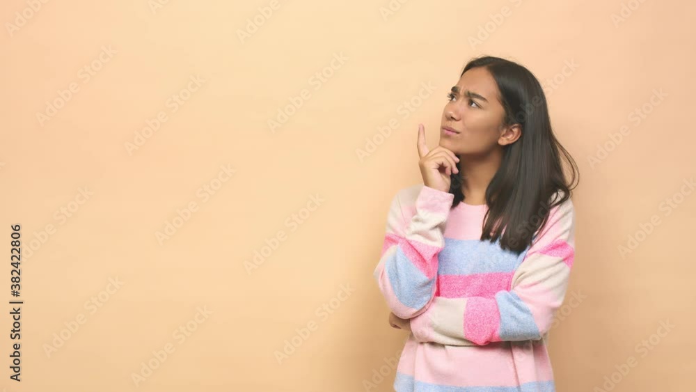 Young mixed race indian woman looking sideways with doubtful and skeptical expression Young mixed race indian woman looking sideways with doubtful and skeptical expression