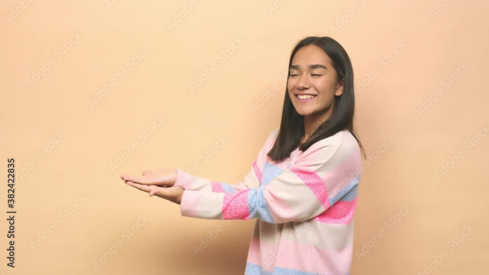 Young mixed race indian woman holding a copy space on a palm Young mixed race indian woman holding a copy space on a palm