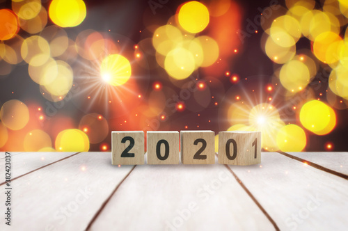 New year 2020 to 2021 on wooden table on abstract bokeh background. Celebration concept and happiness holiday night party idea