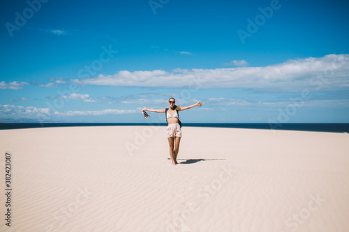 Woman walking on beach near sea