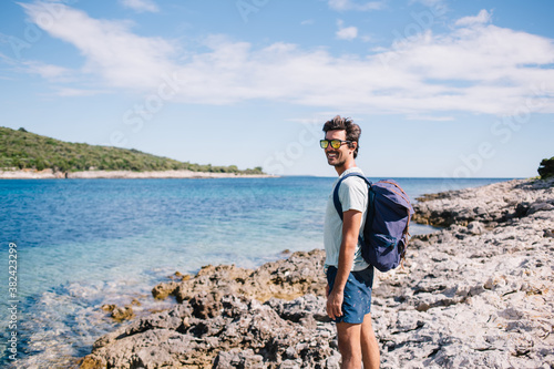 Man with backpack on seashore © BullRun
