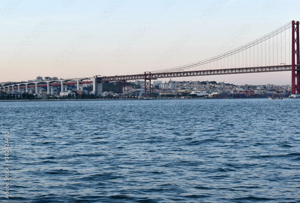 Naklejka premium View of ponte de 25 abril bridge from a boat in the river