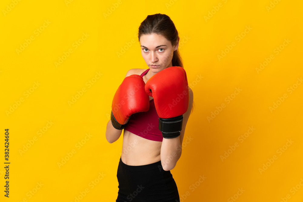 Young Ireland woman isolated on yellow background with boxing gloves