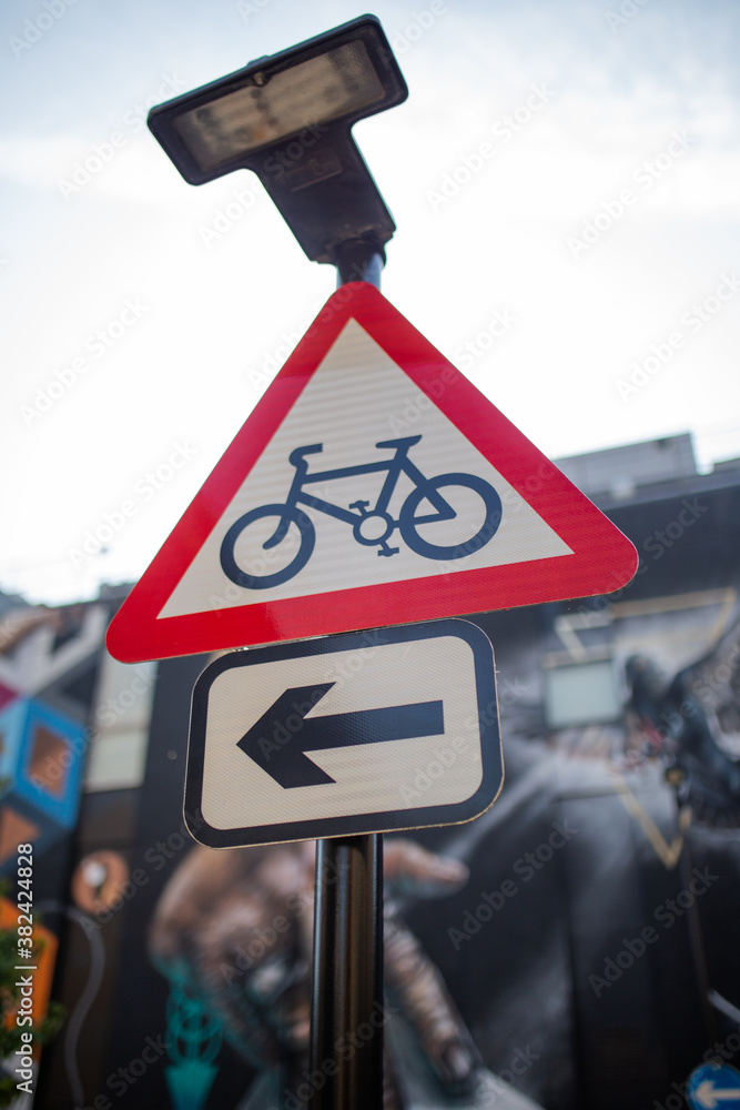 Up Close View of a Triangular Bike Sign with a Colorful Mural in the ...
