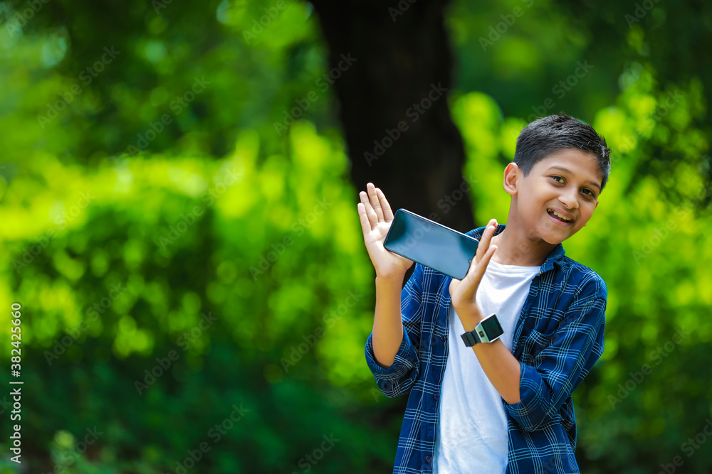 childhood, technology and people concept - indian cute school boy ...