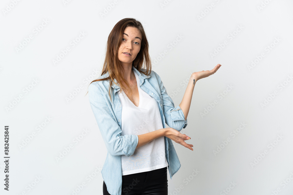 Young Ireland woman isolated on white background extending hands to the side for inviting to come Young Ireland woman isolated on white background extending hands to the side for inviting to come