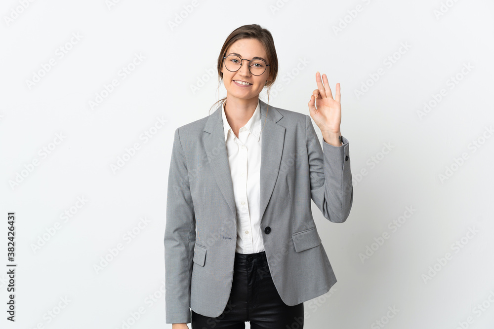 Business Ireland woman isolated on white background showing ok sign with fingers Business Ireland woman isolated on white background showing ok sign with fingers