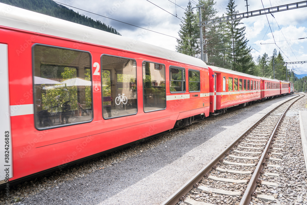 Fototapeta premium Regional train comes to the station, Switzerland
