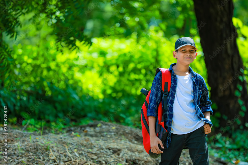 Naklejka premium Indian cute schoolboy with backpack, Back to school concept