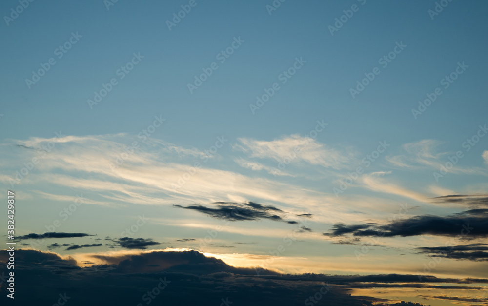 Sunset in the blue sky with white clouds